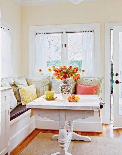 白色枫木板的固定底座与门窗的色彩和质地一脉相承，配合墙壁明亮的色彩与柔软的靠包，空间中充满阳光与温情